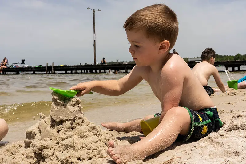 kid playing in the sand