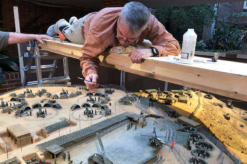 Exhibit designer puts the finishing touches on a Vietnam diorama at the SC Confederate Relic Room