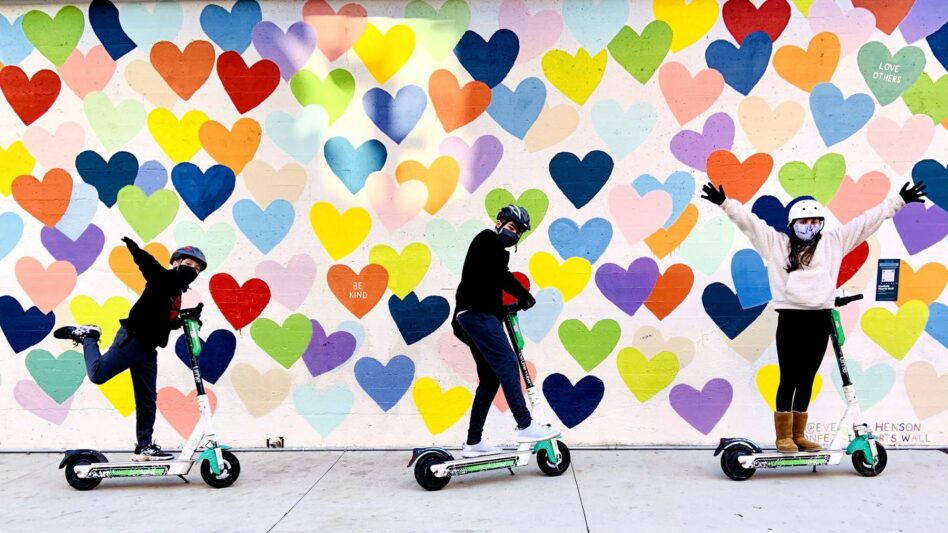 Kids riding scooters on a mural tour in Charlotte