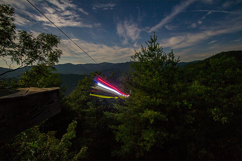 moonlight zipline lights streak across the sky