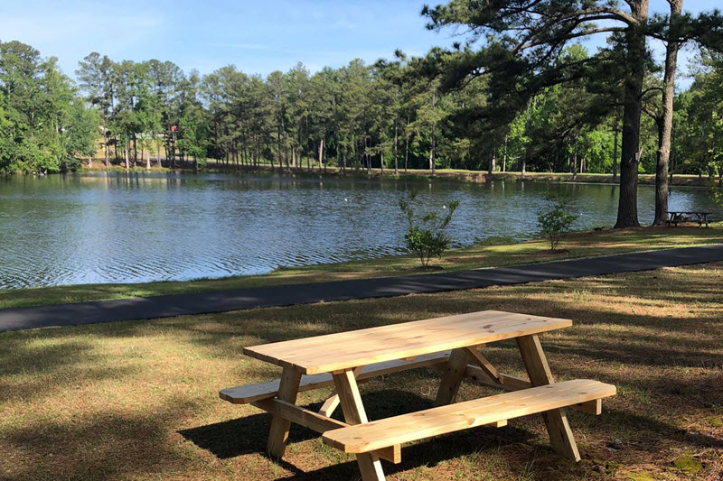 A picnic table sits along side the lake at Watson Lake Park in Sanford