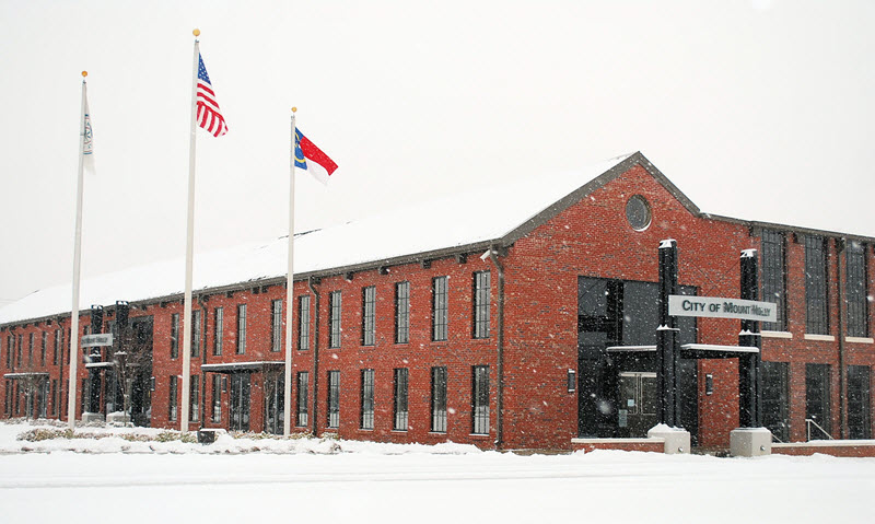 Snow accumulating on a building in Mount Holly