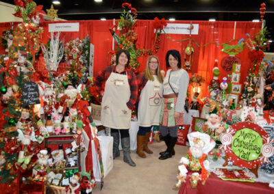 Vendors clad in Victorian attire line the aisles of the Dickens Christmas Festival