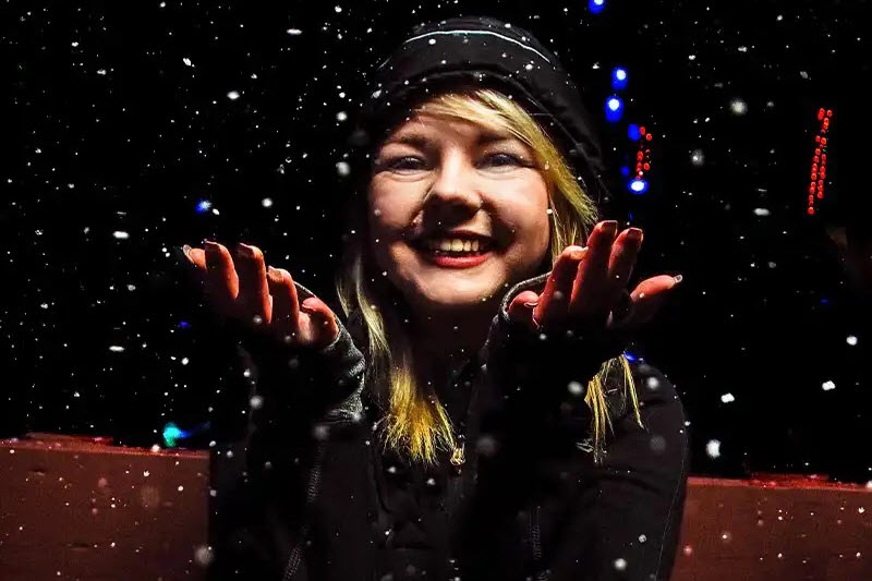 woman catching snowflakes at MacLaurin Farms