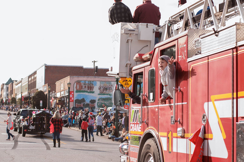 Thomasville residents celebrate Christmas in an annual parade with a firetruck