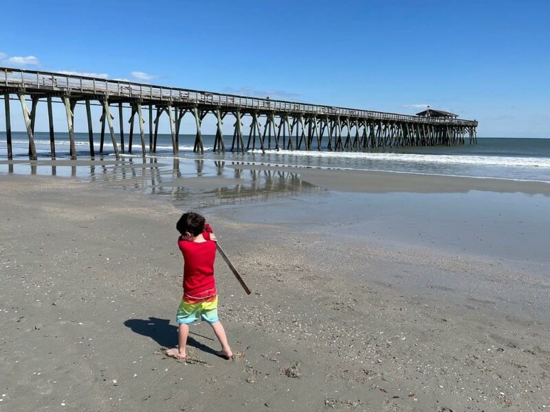 Kid playing at the Myrtle Beach State Park fishing pier