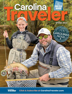 Boy and fly fishing guide display a trout on the cover of Carolina Traveler Magazine