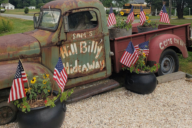 An old rusted truck greets visitors to Hillbilly Hideaway
