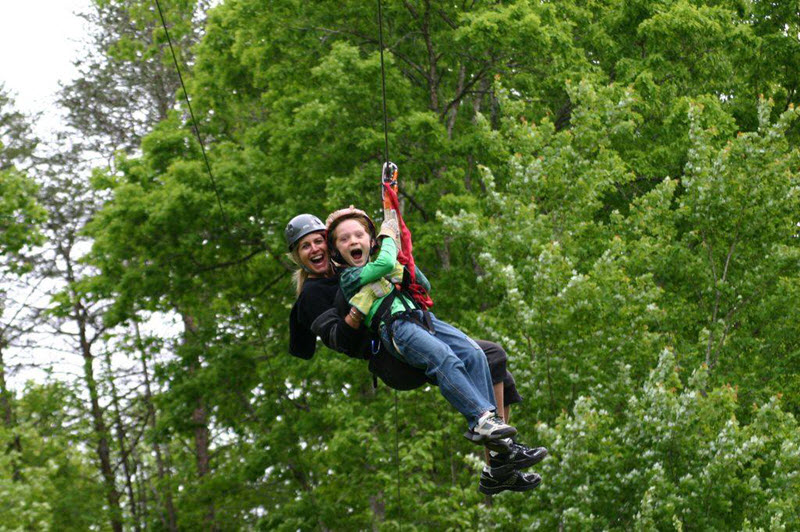 Mother and son ride a zipline in Stokes County, NC