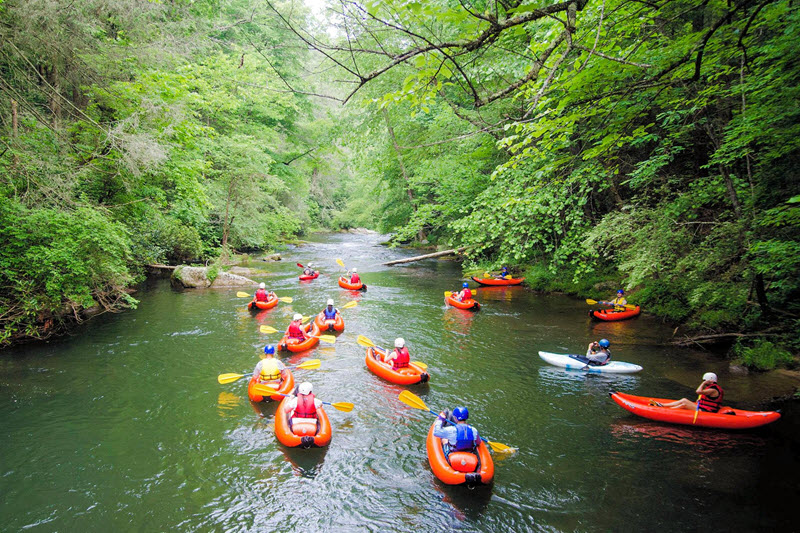 A group of kayakers on the Green River in Saluda, NC.