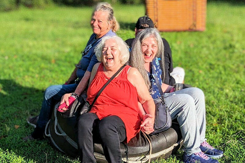 Friends laughing together before a hot air balloon flight