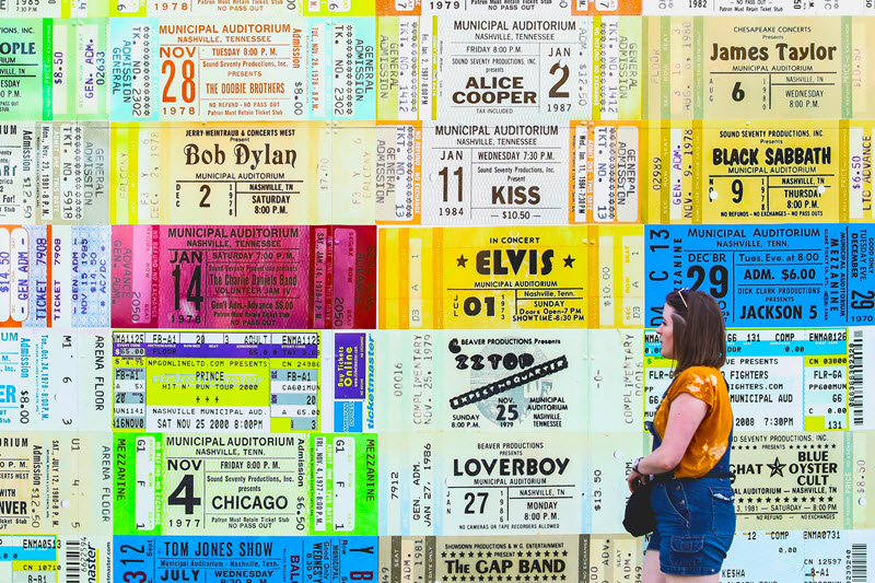 A woman walks past subway posters of show tickets in South Carolina
