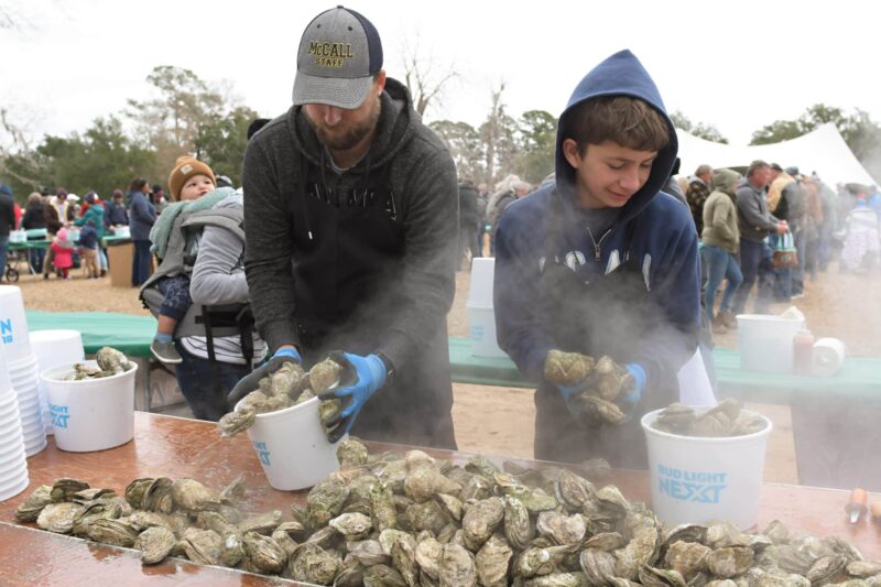 Guys shucking oysters at an SC oyster festival