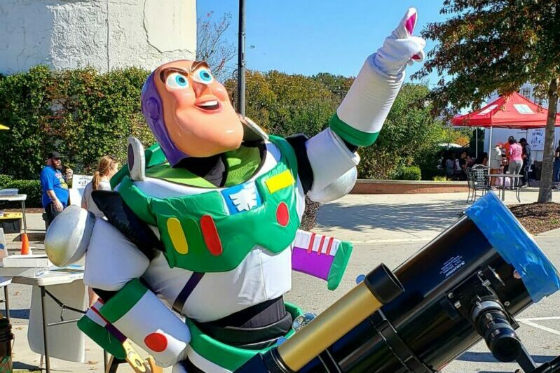Buzz Lightyear pointing upward at the Cummins Planetarium.