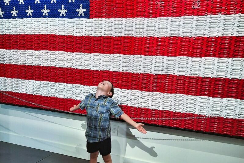 An American flag made out of red, white, and blue kazoos