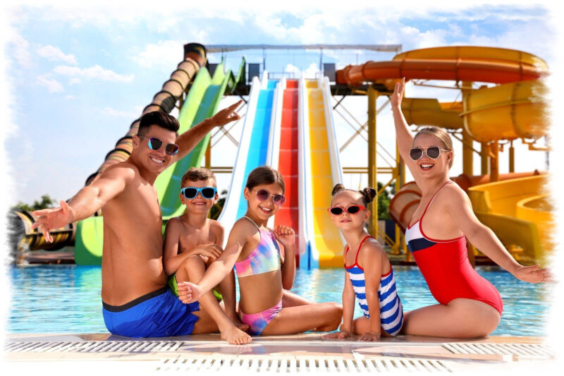 Family posing in front of a waterslide