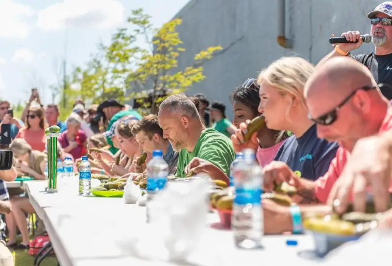 Pickle-eating contest competitors at NC Pickle Fest, one of the best 2024 spring events in NC