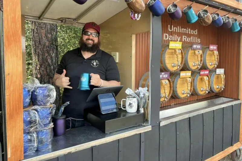 Vendor serving unlimited soda refills at Flowertown Festival
