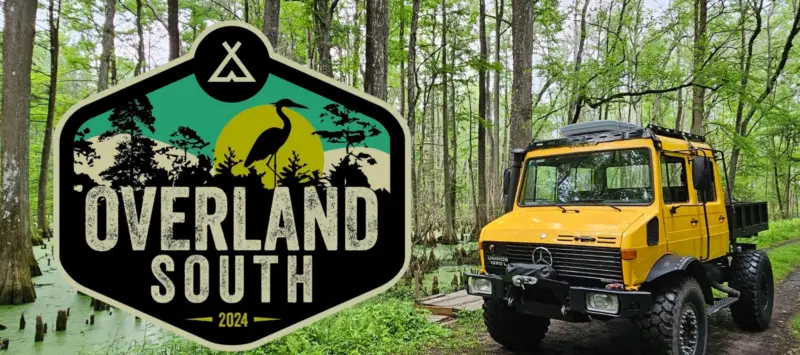 Large overland vehicle with a cypress swamp in the background