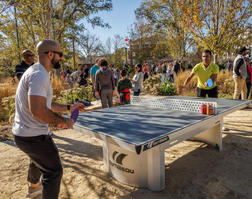 Two guys playing ping pong at Downtown Cary Park