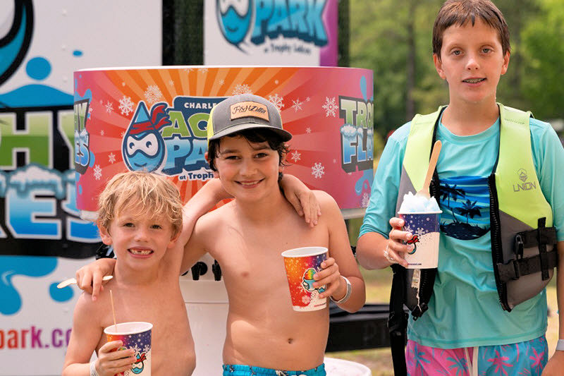 Three boys enjoy shaved ice at the aqua park