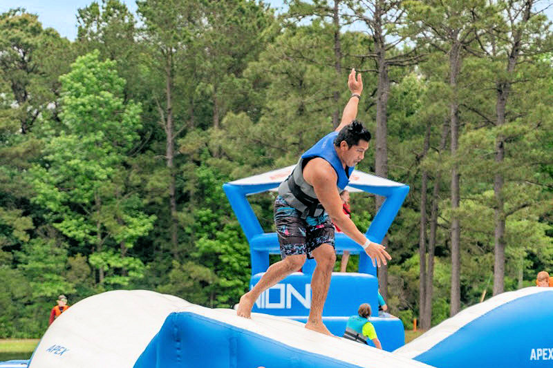 A man navigates the water obstacle course