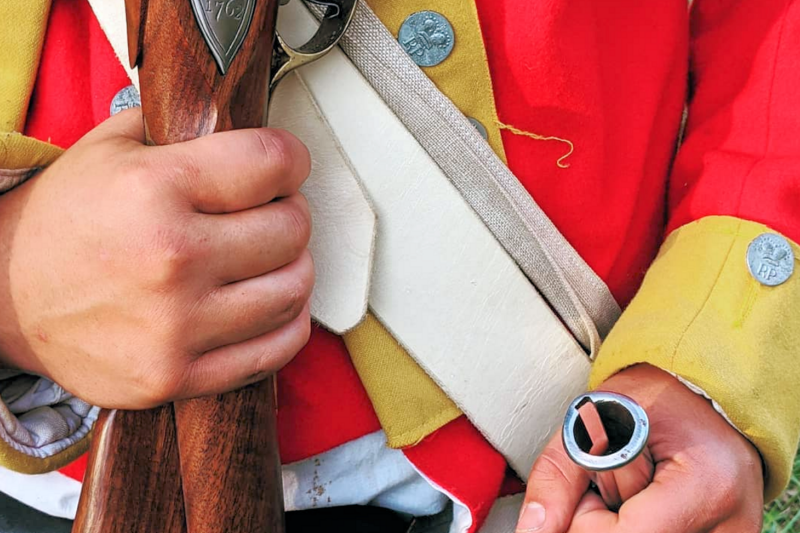 Person dressing up as a Revolutionary War-era soldier at one of the best midsummer 2024 events in the Carolinas