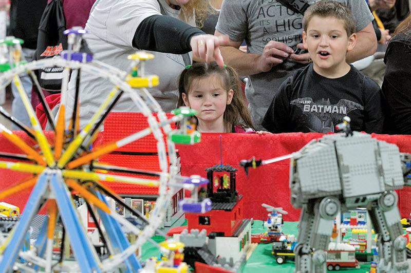 Kids admire a Starwars LEGO display