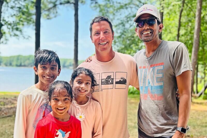 Family of wakeboarders taking a picture with Adam Fields