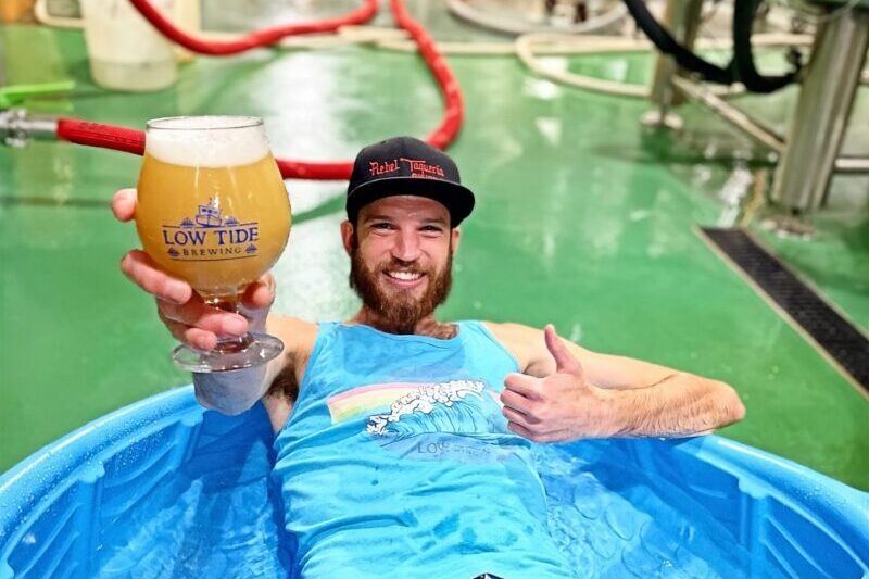 Bartender at Low Tide offering a beer