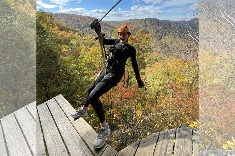 Woman about to step off zip line platform at The Gorge in Saluda, NC