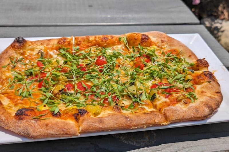 Hand-tossed flatbread with house-made romesco sauce at Slab Town Pizza