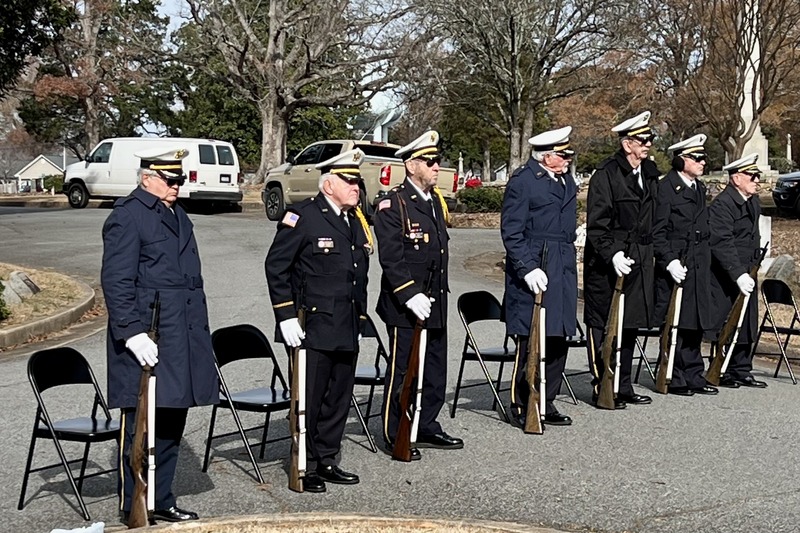 Uniformed veterans stand for the Wreaths Across America service.