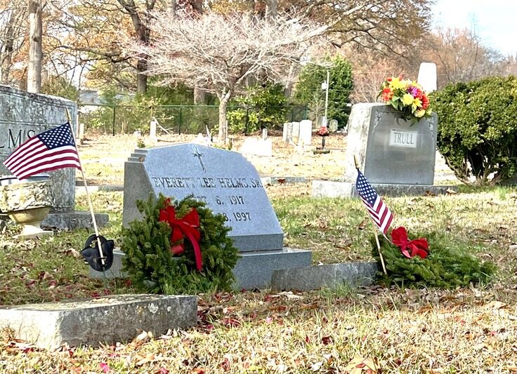 A fresh wreath placed at the headstone of a veteran.