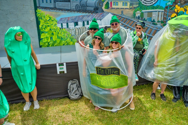 men and women dress up as a bottle of Mt. Olive Kosher Dill Pickles.