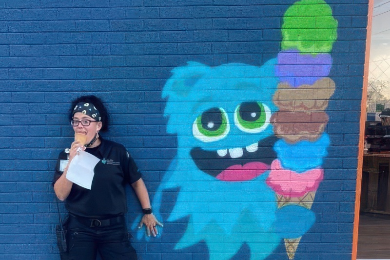 A police officer enjoys an ice cream cone in front of Scoops, in Burgaw, NC